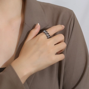 Close-up of Cuban link chain ring with black enamel inlay in polished titanium steel