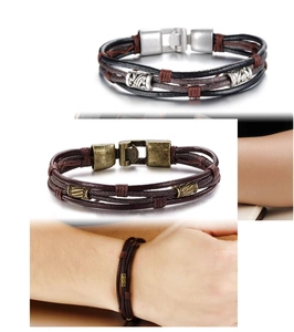 Detail of vintage multilayer braided leather bracelet with retro metal beads and clasp