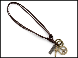 Detail of vintage leather necklace featuring peace sign and cross bronze pendants