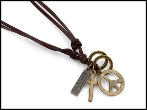Detail of vintage leather necklace with bronze peace sign and engraved metal pendants
