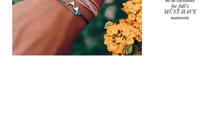 Detail of woven multi-layer bracelets with silver mountain charm on woman wrist