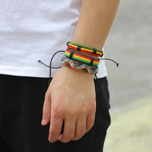 Detail view of handmade braided leather bracelets set with colorful bohemian cords on wrist