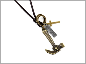 Detailed macro view of retro alloy hammer pendant and leather rope necklace for men