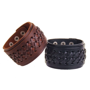 Detail of adjustable leather wristbands with braided center and metal snap buttons