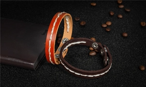 Detail of genuine cowhide leather bracelets with white stitching and silver metal snaps