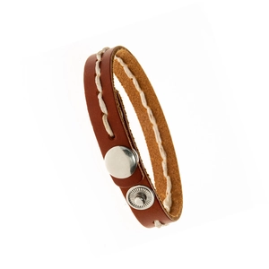 Detailed macro view of brown leather bracelet with white stitching and silver metal snaps