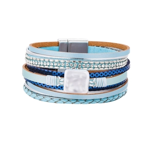 Detail view of multi-layer wrap bracelet with blue leather straps and magnetic clasp