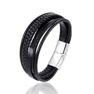 Close-up of multi-layer black braided leather bracelet with polished silver magnetic clasp