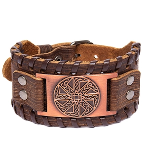 Vintage brown wide leather bracelet featuring a Kolovrat sun wheel symbol and metal buckle