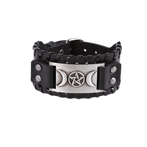 Detail view of men's leather cuff bracelet featuring cross stitching and star metal plate