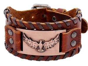 Detail of vintage brown leather bracelet featuring engraved eagle totem and metal studs