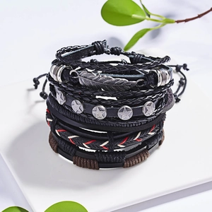 Detail view of multi-layer leather bracelets with feather charm and vintage star studs