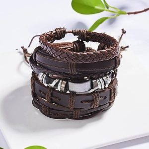 Close-up of vintage multi-layer braided leather bracelets with adjustable cord and metal charms