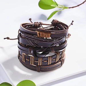 Detailed macro view of retro multi-layer braided leather bracelets in black and brown tones