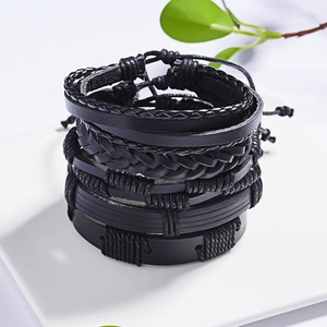 Detailed close-up of layered black leather bracelets with woven straps and adjustable ropes