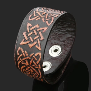 Vintage leather Viking bracelet featuring Celtic knot patterns and silver snap buttons