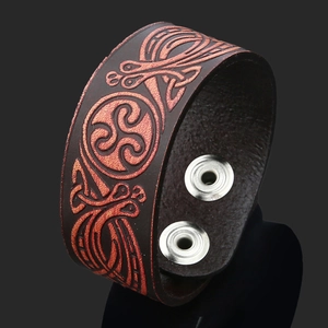 Close-up of brown leather Celtic Triskele cuff bracelet with bronze embossed details