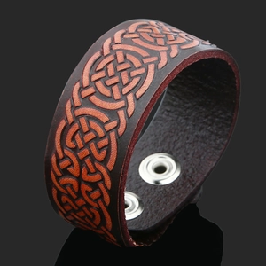 Vintage brown leather wristband with embossed Celtic knot and silver snap buttons