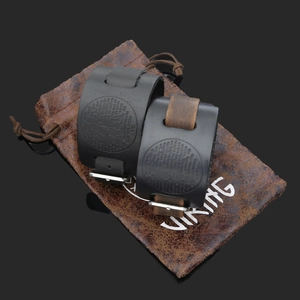 Close-up of vintage Viking leather bracelets with cross compass and Lord's Prayer engraving