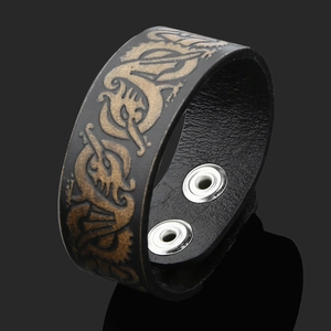 Vintage Viking leather bracelet featuring golden dragon relief and silver metal snap buttons