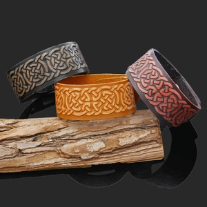 Detailed view of wide leather bracelets with embossed Celtic knots in three retro colors