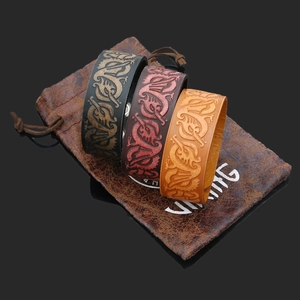 Three handmade leather Viking bracelets with embossed dragon patterns and a branded pouch