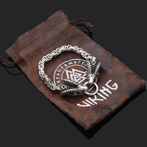 Detail of Viking Thor Hammer bottle opener with ram heads and runic engraving