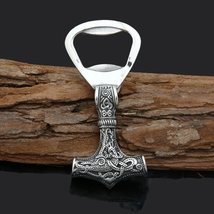 Viking Mjölnir bottle opener made of stainless steel on a rustic wooden background