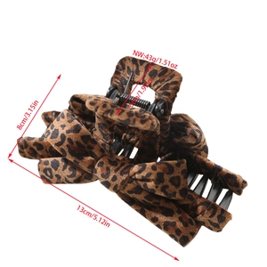 Large leopard print hair claw clip with fabric bow detail and 13cm length measurement