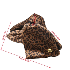 Detail view of leopard print plush makeup bag with gold logo and product dimensions