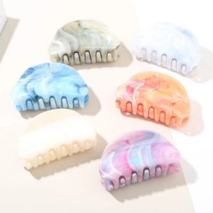 Close-up of marble pattern hair claws in various gradient colors for elegant hair styling