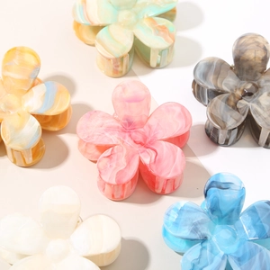 Set of six colorful gradient floral hair claws in pink, blue, yellow, and pastel tones