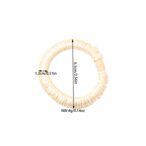 Elastic satin scrunchie in champagne beige with pleated texture, measuring 6.5cm diameter