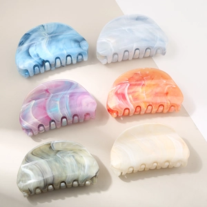 Close-up of 6-piece large marble texture hair claw clips with various color patterns