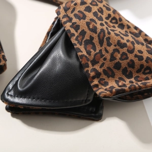 Detail showing the contrast between black leather and leopard print faux fur textures