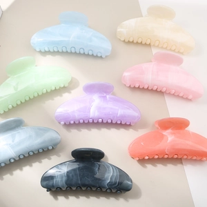 Flat lay view of large gradient marble floral hair claws in eight vibrant pastel colors