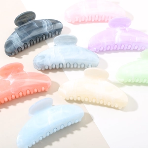 Macro shot showing diverse colors and marbled textures of large acetate hair claw clips