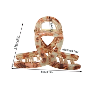 Tortoiseshell acetate hair claw clip with gold spring measuring 8cm by 5.5cm