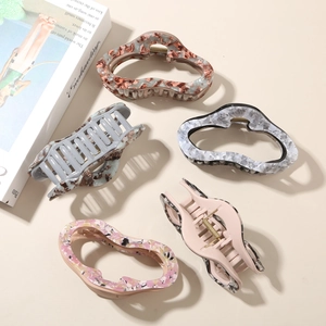 Set of five French vintage acetate hair claws in assorted marble and floral patterns