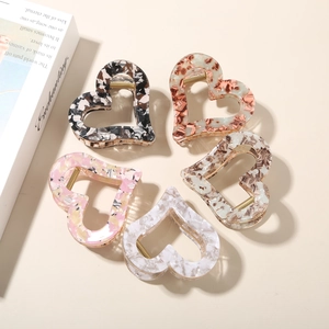 Set of five heart-shaped acetate hair claws with marble textures in various colors