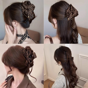 Detail showing leopard print bow hair clips and large claw clips in elegant hairstyles