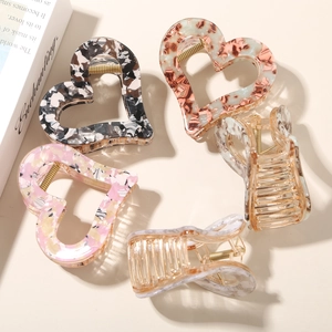Artistic stack of five heart-shaped floral acetate hair claws with gold springs