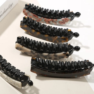 Close-up of five different acetate pattern banana clips with secure black teeth