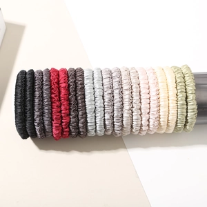 Detailed view of elastic pleated scrunchies set with a silky smooth satin texture