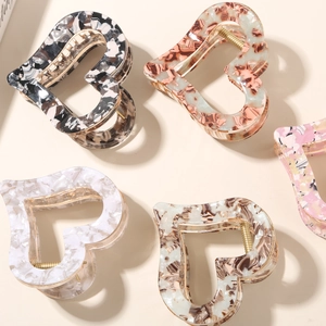 Vintage heart-shaped acetate hair claws in various marble textures and colors