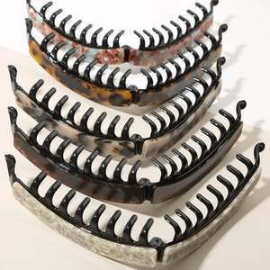 Detail view of five assorted acetate banana clips with stylish leopard and marble patterns