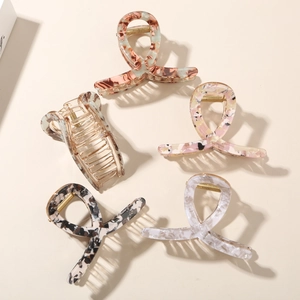 Set of five floral acetate hair claws in marble and tortoiseshell patterns for daily hair styling