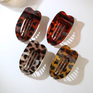 Set of four tortoiseshell hair clips with leopard patterns in various glossy colors