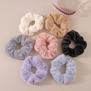 Seven-piece set of soft faux rabbit fur scrunchies in diverse pastel and neutral colors