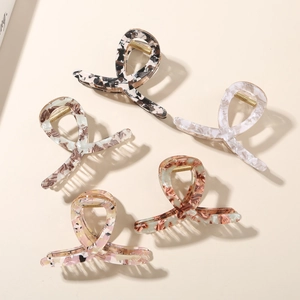 Set of five floral acetate hair claws in various marble and amber patterns
